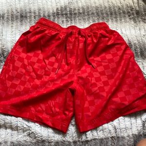 A large (10-12) red checkered jaw string athletic works shorts with pockets